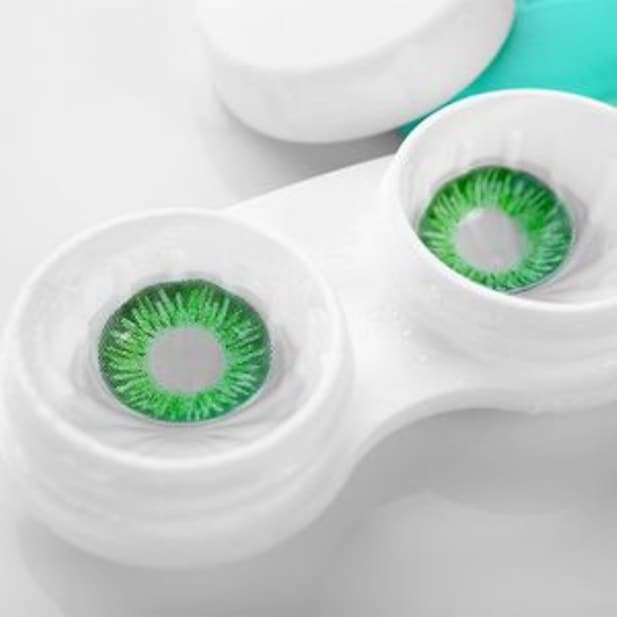 Green coloured contacts in a lens case